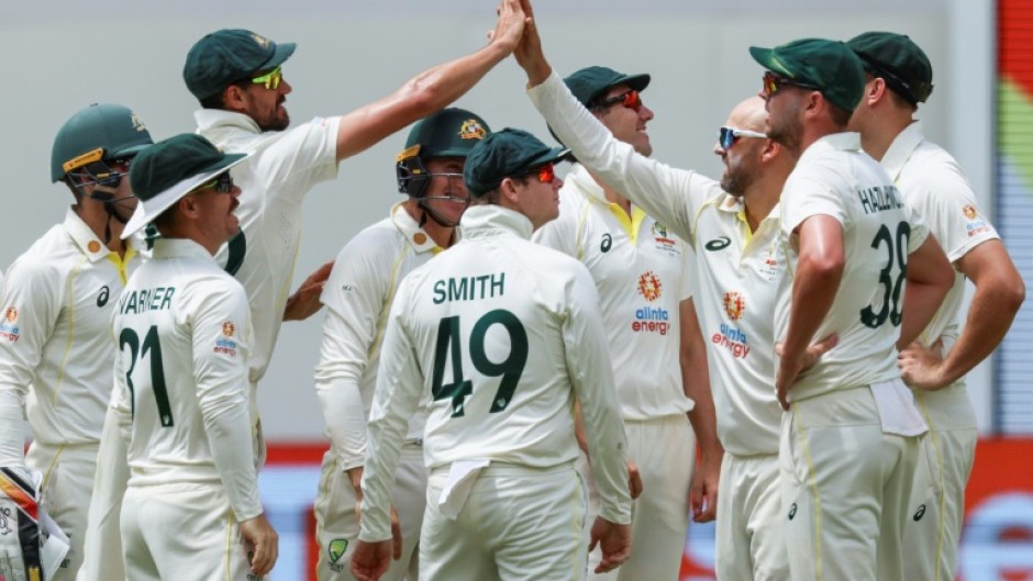 Australia's Nathan Lyon (3rd R) celebrates after taking the wicket of West Indies' Kraigg Brathwaite 