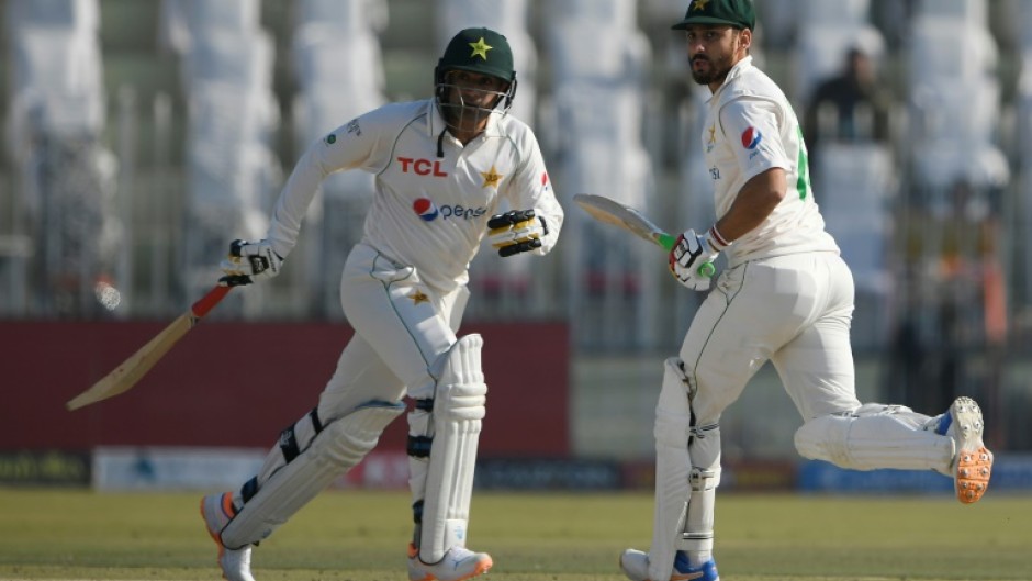 Pakistan's Salman Ali Agha (right) and teammate Zahid Mahmood run between wickets in Rawalpindi