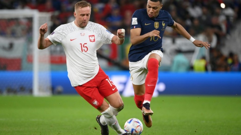 France forward Kylian Mbappe races away from Poland's Kami Glik during Les Bleus' last 16 victory