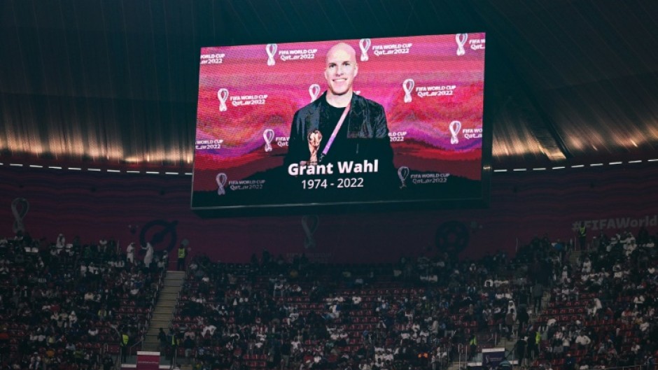 A giant screen at the Al Bayt Stadium where England played France at the World Cup shows a tribute to US reporter Grant Wahl who died covering a match the day before