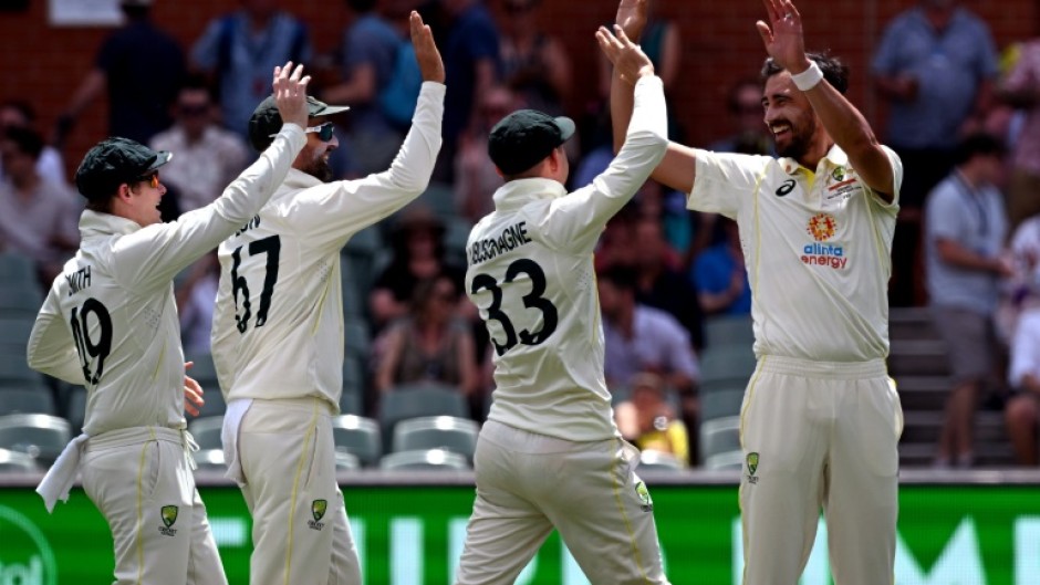 Australia's Mitchell Starc (R) celebrates after running out Tagenarine Chanderpaul of the West Indies
