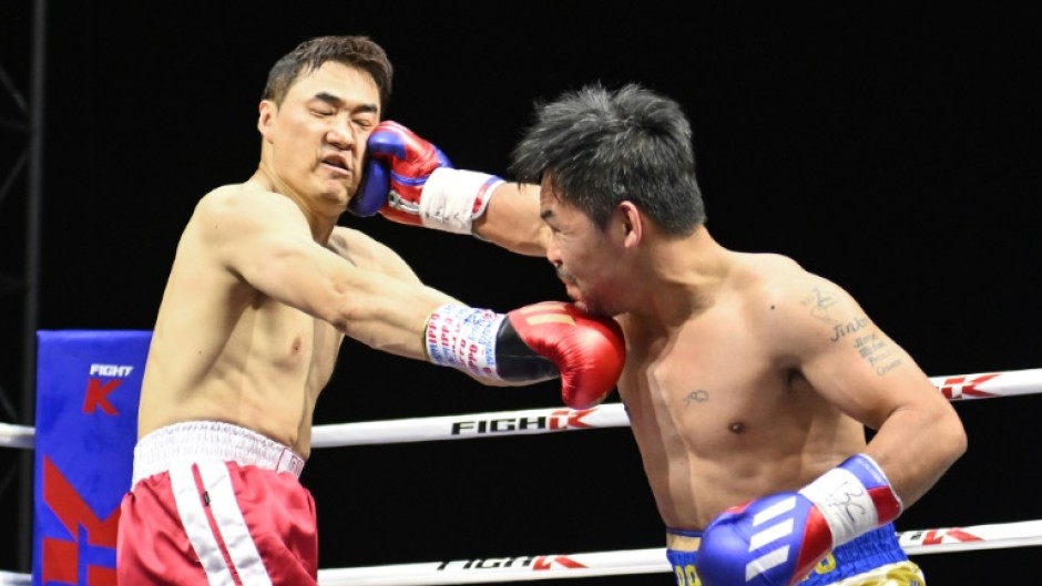 Pacquiao (R) lands one on D.K. Yoo in Goyang, South Korea, on Sunday