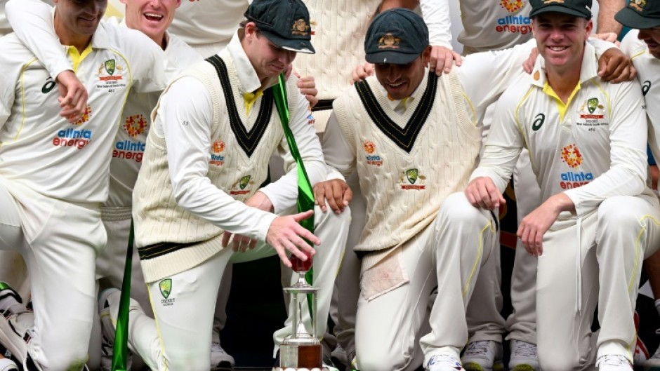 The Australian team pose with the series trophy after winning the second Test between Australia and the West Indies 