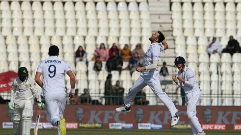 England's Mark Wood  celebrates after taking the wicket of Pakistan's Zahid Mahmood
