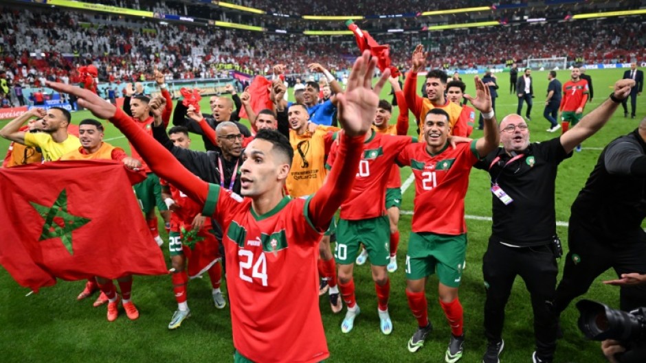 Morocco players celebrate with their supporters after they beat Portugal in the World Cup quarter-finals