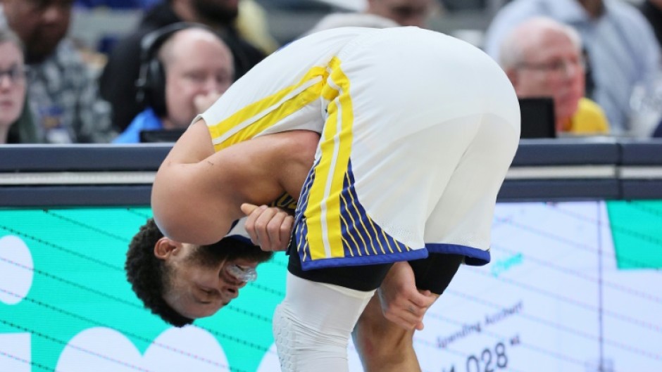 Golden State's Stephen Curry grimaces after suffering a left shoulder injury in the third quarter of the Warriors' 125-119 loss at Indiana 