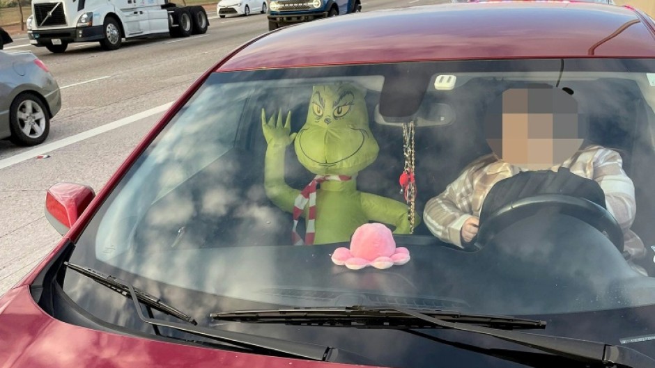 Arizona police fined a driver for using a restricted carpool lane with an inflatable Grinch in the passenger seat 