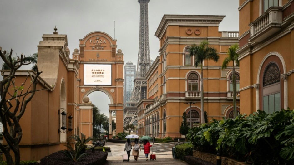 Visitors walk on the Cotai Strip, Macau's main gambling area, on Friday