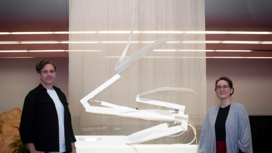 Dutch artist Thijs Biersteker (L) and scientist Adriana de Palma pose in front of "ECONARIO" an art installation by Biersteker, during the United the Nations Biodiversity Conference (COP15) in Montreal