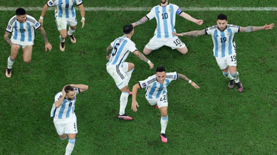 Lionel Messi (2nd R) celebrates after winning the World Cup with Argentina