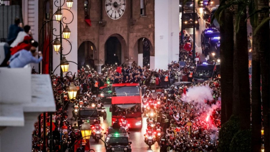 Many supporters, clad in the team's kits and waving red flags, had waited hours to see their heroes