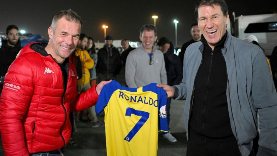 Name game: Former world rally champion Sebastien Loeb (left) is presented with a Cristiano Ronaldo Al-Nassr shirt by the club's French coach Rudi Garcia at the Dakar Rally in Riyadh on Sunday