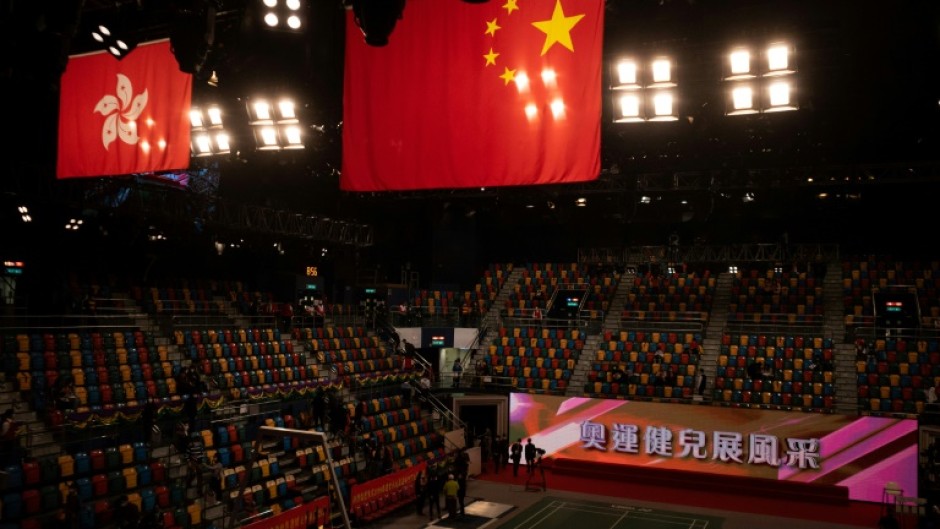 Flags of China (R) and Hong Kong hang above Hong Kong’s Queen Elizabeth Stadium