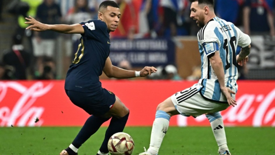 Kylian Mbappe and Lionel Messi come up against each other during last month's World Cup final