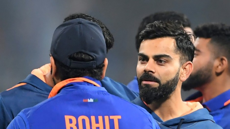 India's Virat Kohli (R) speaks with Rohit Sharma
