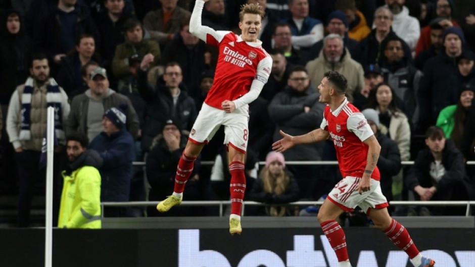 Soaring clear: Martin Odegaard (centre) scored as Arsenal moved eight points clear at the top of the Premier League