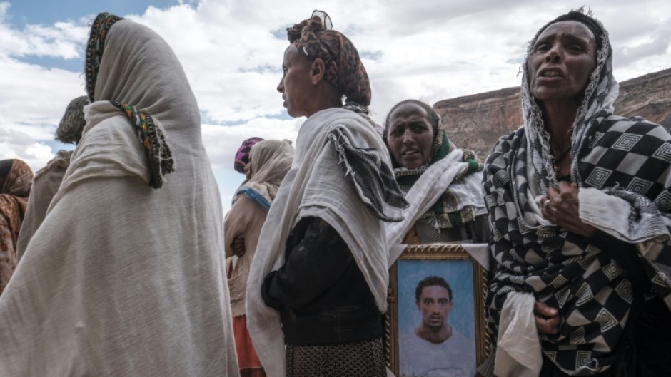 People mourn the victims of a massacre allegedly perpetrated by Eritrean soldiers in the village of Dengolat, north of Mekele, the capital of Tigray on February 26, 2021