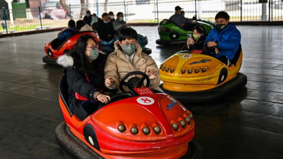 People enjoy a bumper car ride at Zhongshan Amusement Park in Wuhan