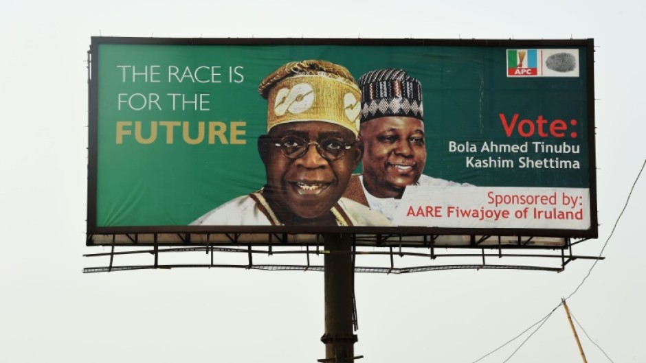 Ruling APC party candidate Bola Tinubu, seen here on a campaign poster, says the fuel and cash crisis is a bid to undermine him