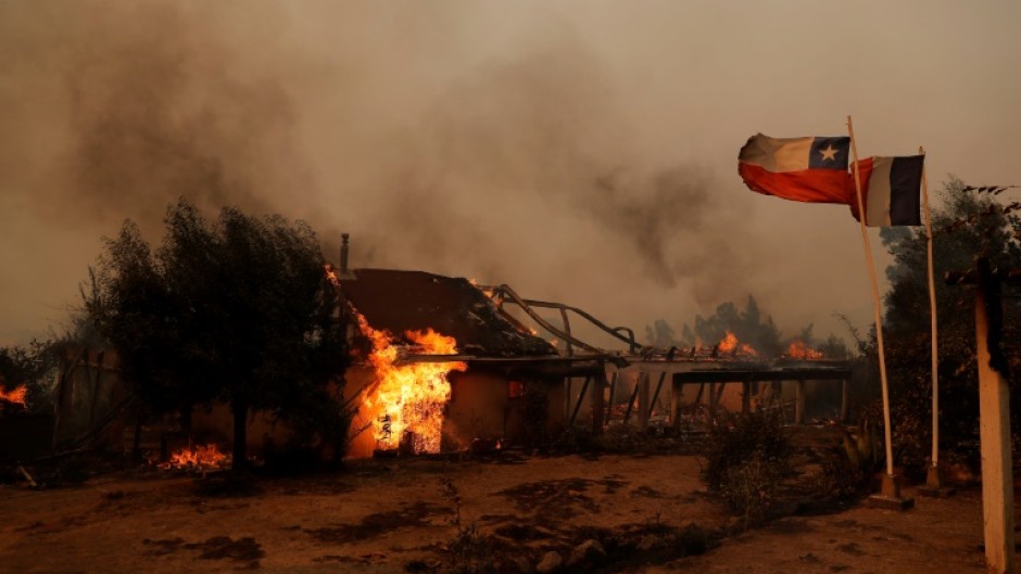 Flames consume a house during a fire in Santa Juana, Concepcion province, Chile on February 3, 2023