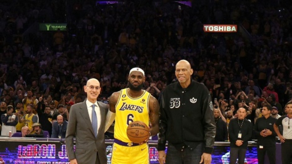 NBA Commissioner Adam Silver, LeBron James and Kareem Abdul-Jabbar stand on court after James became the NBA's all-time leading scorer on Tuesday