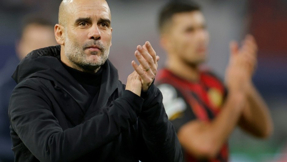 'Nine strikers': Manchester City coach Pep Guardiola applauds the fans in Leipzig