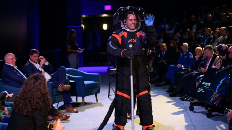 The spacesuit modeled by Jim Stein featured a cover layer in all black with blue and orange trim which Axiom Space said was required to 'conceal the suit's proprietary design'