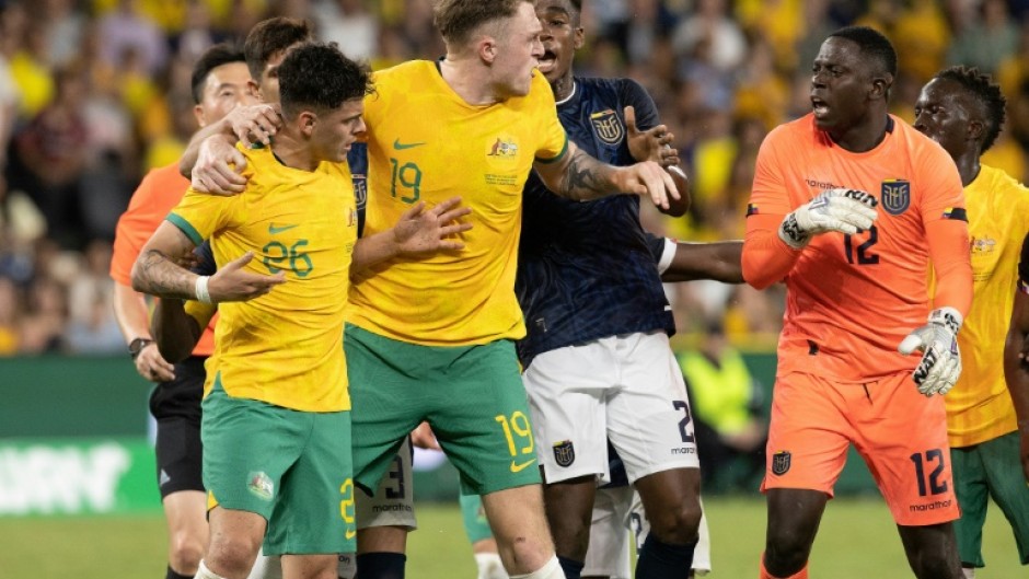 Alex Robertson (left) is protected by teammate Harry Souttar during a scuffle against Ecuador