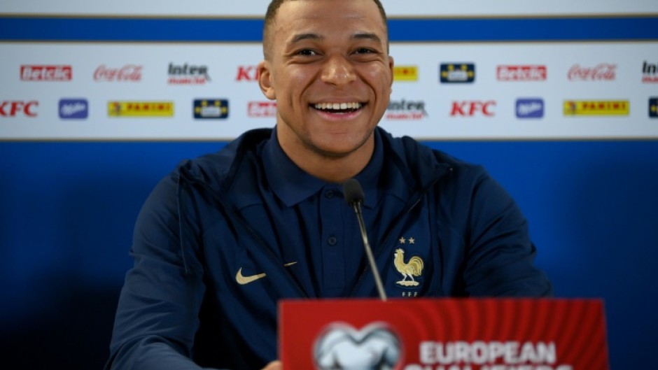 France striker Kylian Mbappe smiles during a press conference on the eve of a Euro 2024 qualifier against the Republic of Ireland in Dublin