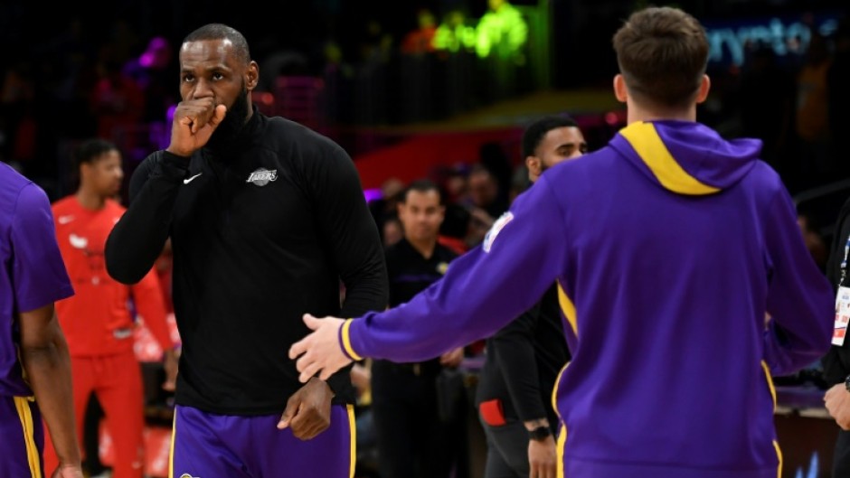 LeBron James and Austin Reaves of the Los Angeles Lakers warm up ahead of the game against Chicago