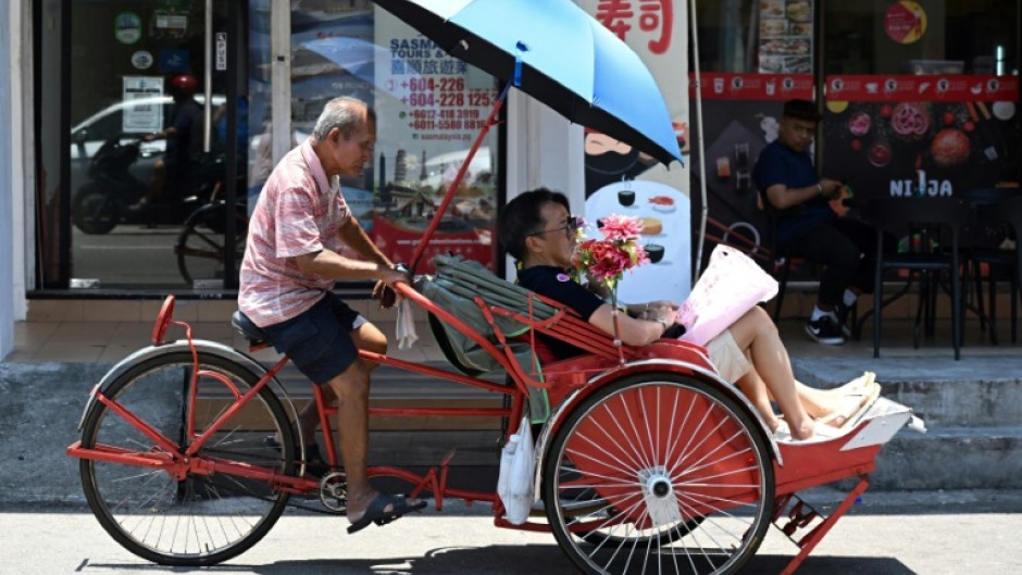There are just over 130 trishaws in Penang where the handlers pedal from behind their patrons
