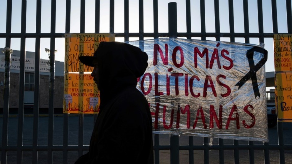 'No more inhuman policies,' reads a sign outside the detention center where 38 migrants died in a fire in northern Mexico