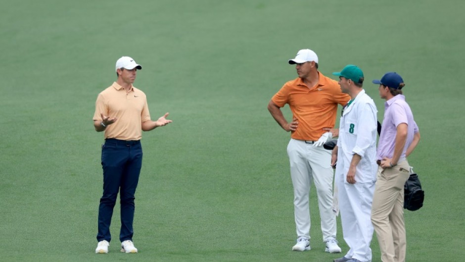Rory McIlroy talks with Brooks Koepka, who plays in the upstart LIV Golf League, during practice on Tuesday for this week's Masters tournament at Augusta National
