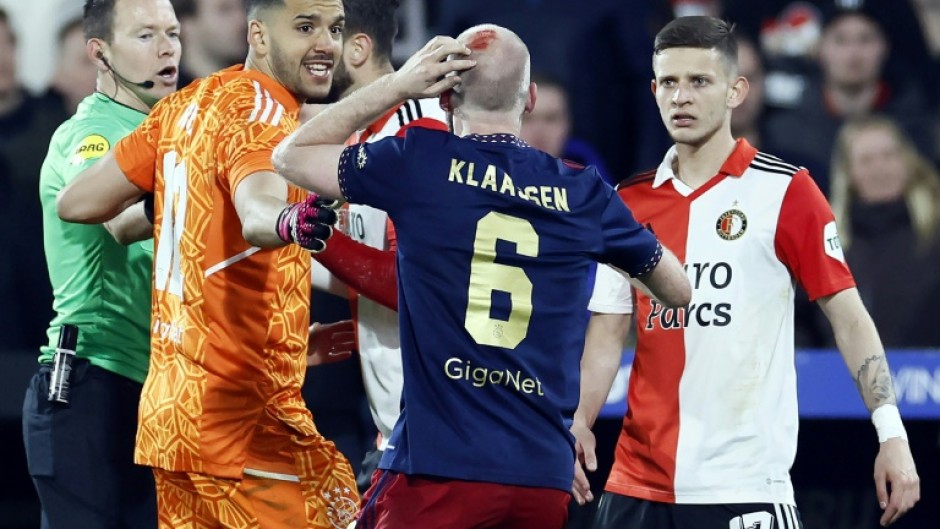 The Dutch cup semi-final was interrupted for almost half an hour when a lighter thrown from the stands hit Ajax player Davy Klaassen in the head