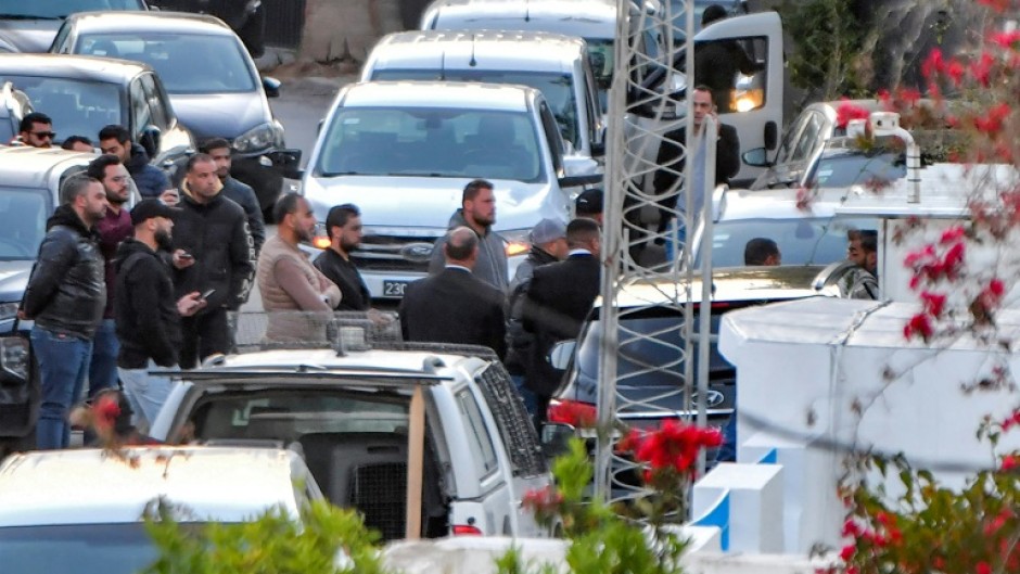 Members of Tunisia's security forces gather during the raid to arrest Ghannouchi at his home