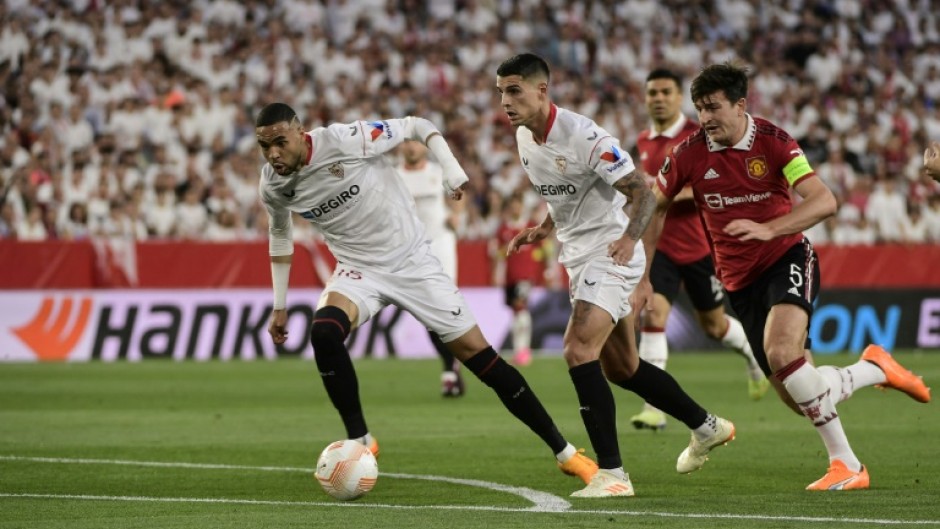 Youssef En-Nesyri (L) fires Sevilla ahead as Harry Maguire, who gave the ball away, chases in vain