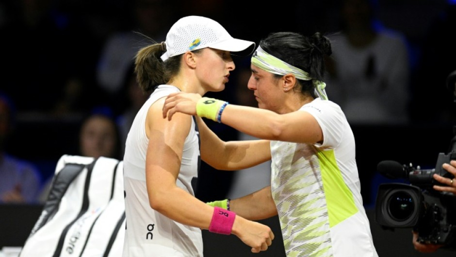 Iga Swiatek (L) consoles Ons Jabeur after the Tunisian is forced to retire in their Stuttgart semi-final