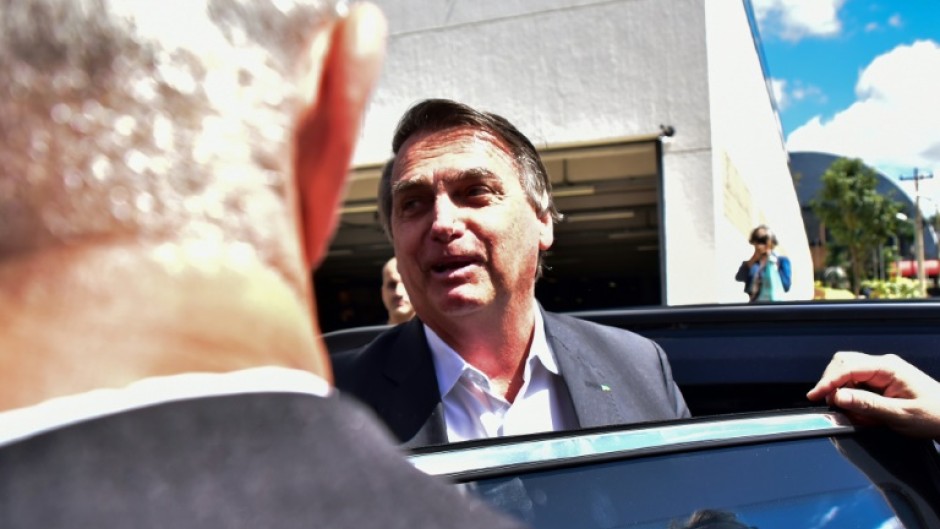 Brazilian ex-president Jair Bolsonaro speaks to the media after testifying in Brasilia on April 26, 2023