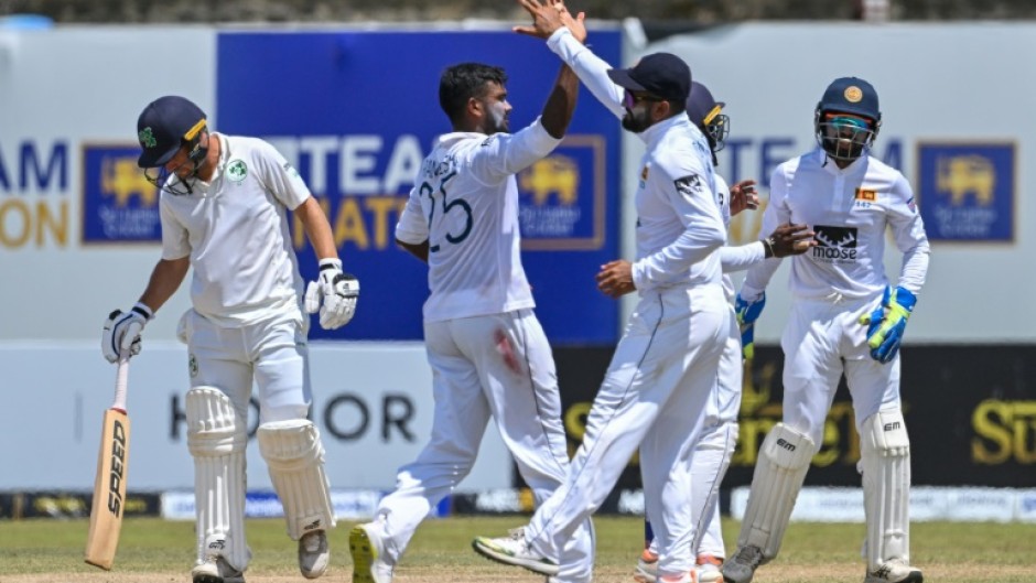 Sri Lanka's Ramesh Mendis (2L) celebrates with teammates after taking the wicket of Ireland's Andrew McBrine