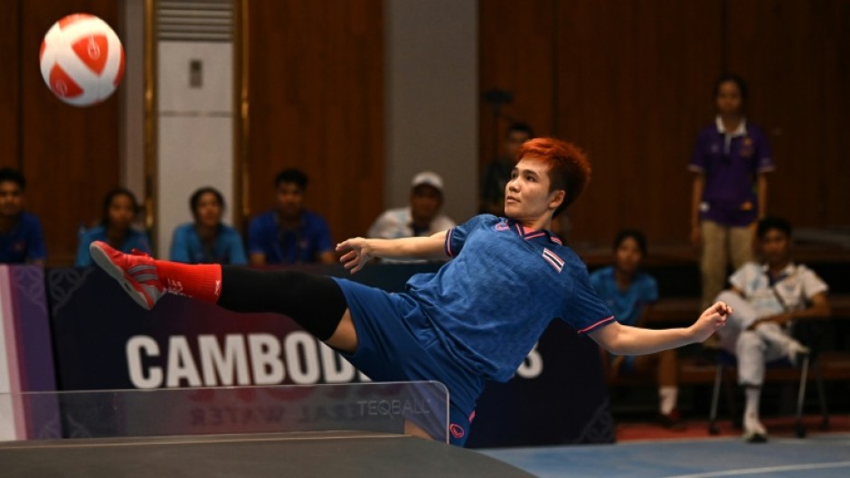 Thailand's Suphawadi Wongkhamchan in doubles action against one of two Cambodian sides in Phnom Penh