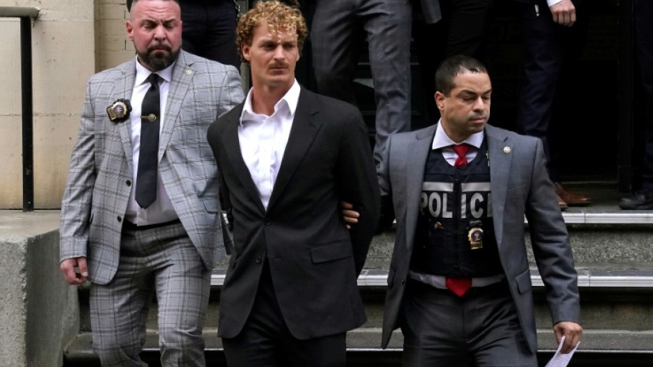 US Marine veteran Daniel Penny (C) is walked out of the New York Police Department 5th Precinct in Lower Manhattan, May 12, 2023, on his way to an arraignment for charges in the chokehold death of Jordan Neely