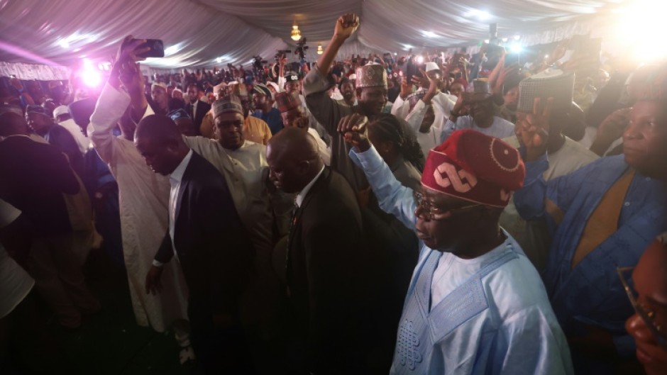 Nigerian ruling party candidate Bola Tinubu acknowledges supporters in Abuja on March 1, 2023 during celebrations on his election win in Abuja