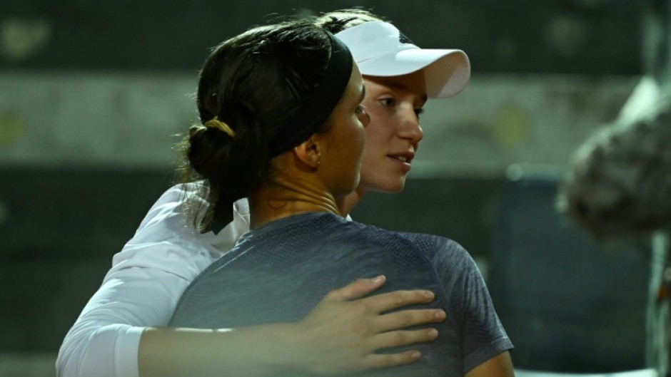 Champion's embrace: Elena Rybakina (right) consoles Anhelina Kalinina 