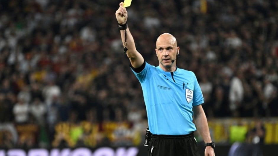 English referee Anthony Taylor shows a yellow card during the UEFA Europa League final