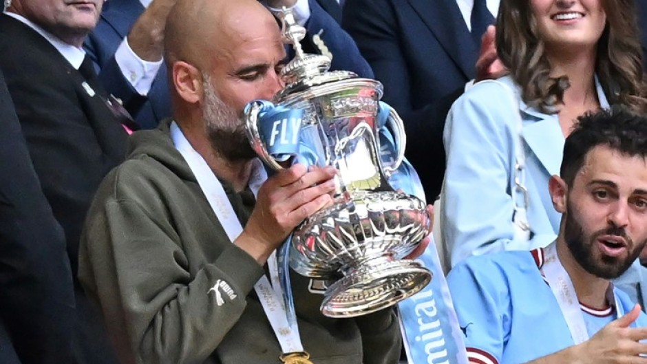 Manchester City boss Pep Guardiola holding the FA Cup after his team beat Manchester United in last week's final