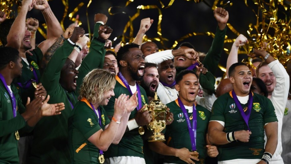Captain Siya Kolisi (C) holds the Webb Ellis Cup after South Africa beat England in the 2019 Rugby World Cup final in Japan. 