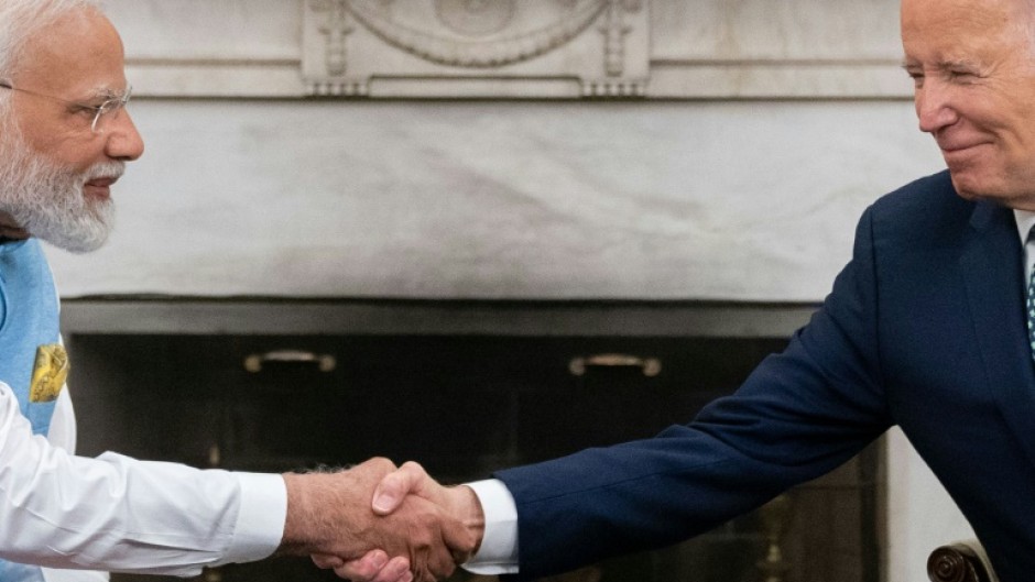 US President Joe Biden shakes hands with India's Prime Minister Narendra Modi in the Oval Office of the White House 