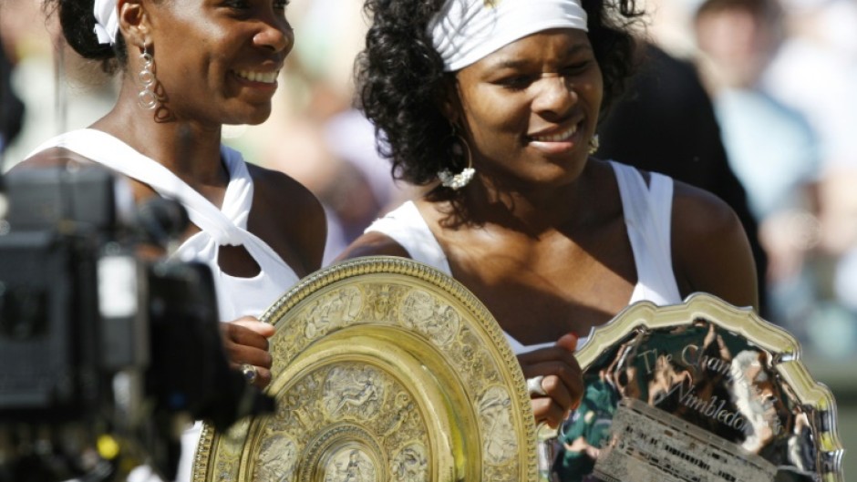 Family ties: Venus Williams with sister  Serena after winning the 2008 Wimbledon final 