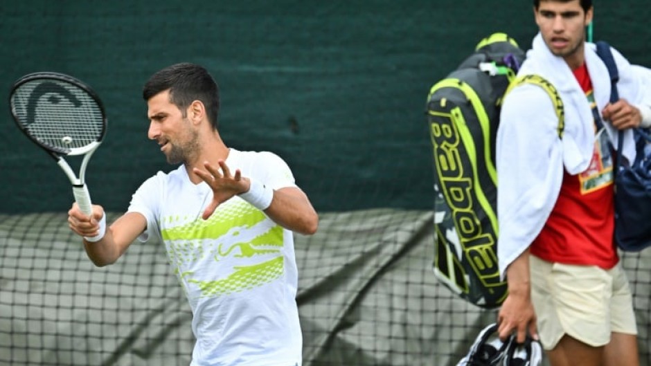 Close quarters: Carlos Alcaraz watches Novak Djokovic train at the All England Club on Sunday