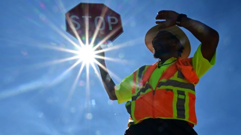 A traffic warden in Las Vegas mans his street corner in searing heat in Las Vegas, Nevada